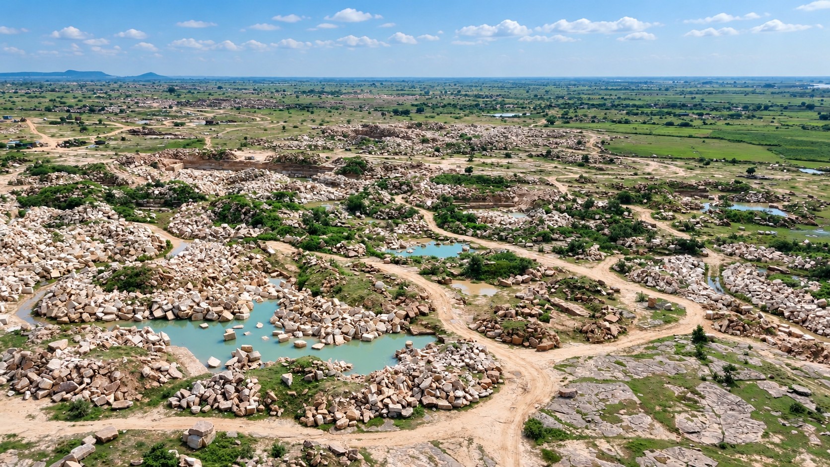 Aerial view of the Sil Shakti quarry with sandstone blocks and water